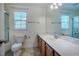 Well-lit bathroom with a vanity, toilet, and mirror at 111 Florians Dr, Holly Springs, NC 27540