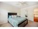 Cozy bedroom with queen-sized bed and a ceiling fan at 111 Florians Dr, Holly Springs, NC 27540