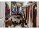 Walk-in closet filled with hanging clothes and shoes at 111 Florians Dr, Holly Springs, NC 27540