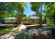 Community center with beautifully landscaped grounds and mature trees and sidewalk at 111 Florians Dr, Holly Springs, NC 27540