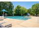 Community pool with lifeguard stand, slide, and ample seating, surrounded by lush greenery at 111 Florians Dr, Holly Springs, NC 27540