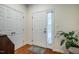 Bright entryway with hardwood floors, coat closet, and front door, providing a warm welcome at 111 Florians Dr, Holly Springs, NC 27540