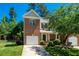 Charming brick two-story home with well-manicured lawn and attached garage on a beautiful sunny day at 111 Florians Dr, Holly Springs, NC 27540