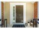 Stylish brown front door with sidelight and matte providing an inviting entryway ambiance at 111 Florians Dr, Holly Springs, NC 27540