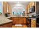 Well-lit kitchen featuring granite counters, tiled backsplash, and stainless steel appliances at 111 Florians Dr, Holly Springs, NC 27540
