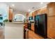 Charming kitchen featuring wood cabinets, granite counters, and modern black appliances at 111 Florians Dr, Holly Springs, NC 27540