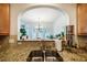 Kitchen sink with granite counters, a tiled backsplash, and a view into the dining area at 111 Florians Dr, Holly Springs, NC 27540