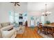 Open-concept living room with fireplace and abundant windows, perfect for relaxing and entertaining at 111 Florians Dr, Holly Springs, NC 27540