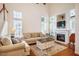 Bright living room with fireplace and soaring ceilings, offering a spacious and airy atmosphere at 111 Florians Dr, Holly Springs, NC 27540
