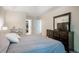 Spacious main bedroom featuring a king bed, dresser with a mirror, and a walk-in closet at 111 Florians Dr, Holly Springs, NC 27540
