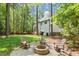 Charming backyard featuring brick firepit, Adirondack chairs and mature trees at 112 Parkspring Ct, Cary, NC 27519