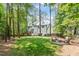 Beautiful backyard featuring a lush lawn, fire pit, and view of the home's exterior at 112 Parkspring Ct, Cary, NC 27519