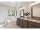 Bright bathroom with soaking tub, glass shower, double vanity, and granite counters at 112 Parkspring Ct, Cary, NC 27519