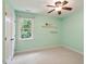 Bedroom with pale green walls, window view, and white trim and doors at 112 Parkspring Ct, Cary, NC 27519