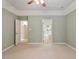 Bedroom with neutral walls, large windows, and an open doorway to bathroom at 112 Parkspring Ct, Cary, NC 27519