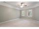 Spacious bedroom with large windows and a ceiling fan at 112 Parkspring Ct, Cary, NC 27519