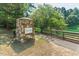 Stone entrance to West-Park community with water feature and walking path visible beyond at 112 Parkspring Ct, Cary, NC 27519