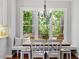 Cozy dining nook with bench seating, a wooden table, and a view of the trees at 112 Parkspring Ct, Cary, NC 27519