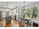 Kitchen dining nook with windows overlooking the backyard and elegant chandelier lighting at 112 Parkspring Ct, Cary, NC 27519