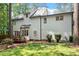 Back of a two-story home featuring a wood deck and spacious yard and manicured landscaping at 112 Parkspring Ct, Cary, NC 27519