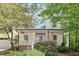 Charming front exterior with a welcoming porch, an American flag, and beautiful landscaping at 112 Parkspring Ct, Cary, NC 27519
