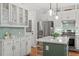 Contemporary kitchen showcasing a center island, stainless steel refrigerator, and tile backsplash at 112 Parkspring Ct, Cary, NC 27519