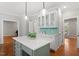 Kitchen island with a white countertop and hardwood floors, with an open floorplan view at 112 Parkspring Ct, Cary, NC 27519