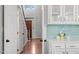 Bright kitchen with white cabinets, blue backsplash, and modern countertops at 112 Parkspring Ct, Cary, NC 27519
