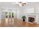 Bright living room with fireplace and sliding glass doors to the deck at 112 Parkspring Ct, Cary, NC 27519