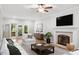 Inviting living room featuring a brick fireplace and access to outdoor deck at 112 Parkspring Ct, Cary, NC 27519
