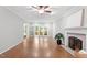 Living room with fireplace and sliding glass doors to outdoor deck at 112 Parkspring Ct, Cary, NC 27519