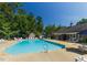 Sparkling outdoor swimming pool surrounded by lounge chairs and lush greenery creating a resort atmosphere at 112 Parkspring Ct, Cary, NC 27519