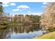 Scenic waterfront property with lush landscaping and serene lake views in a peaceful community at 112 Parkspring Ct, Cary, NC 27519