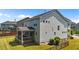 The backyard features a covered porch, lawn, and black aluminum fence, providing a relaxing outdoor space at 116 Chaseford Ct, Holly Springs, NC 27540