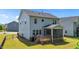 The backyard offers a view of the home's deck and the exterior of the property, surrounded by well-maintained grass at 116 Chaseford Ct, Holly Springs, NC 27540