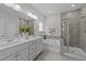 Modern bathroom featuring a double vanity, soaking tub, and a glass-enclosed shower at 116 Chaseford Ct, Holly Springs, NC 27540