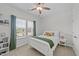 Cozy bedroom with natural light from a bright window and a ceiling fan for added comfort at 116 Chaseford Ct, Holly Springs, NC 27540