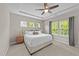 Bright bedroom with a tray ceiling, a comfortable bed, and natural light from the windows at 116 Chaseford Ct, Holly Springs, NC 27540