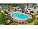 Community pool with lounge chairs, tables, and a well-maintained pool house in a landscaped setting at 116 Chaseford Ct, Holly Springs, NC 27540