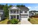 Charming two-story home featuring a double-decker porch, neutral siding, and an attached two-car garage at 116 Chaseford Ct, Holly Springs, NC 27540
