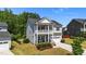 Inviting two-story home with a double porch and manicured landscaping, offering great curb appeal at 116 Chaseford Ct, Holly Springs, NC 27540