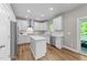 Bright and modern kitchen with an island, stainless steel appliances, and white cabinets at 116 Chaseford Ct, Holly Springs, NC 27540