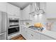 Well-appointed kitchen featuring stainless appliances, gas range, and white cabinetry with modern finishes at 116 Chaseford Ct, Holly Springs, NC 27540