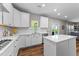 Modern kitchen boasting white cabinetry, stainless steel appliances, and a stylish island at 116 Chaseford Ct, Holly Springs, NC 27540