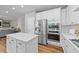 Bright kitchen featuring white cabinets, stainless steel appliances, and a central island at 116 Chaseford Ct, Holly Springs, NC 27540