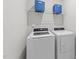 Convenient laundry room features a washer, dryer, and shelving for organized storage at 116 Chaseford Ct, Holly Springs, NC 27540