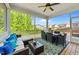 Relaxing screened porch with comfortable seating, a ceiling fan, and a view of the backyard at 116 Chaseford Ct, Holly Springs, NC 27540