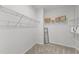 Bright walk-in closet features wire shelving, a mirror, and neutral carpeting for ample storage at 116 Chaseford Ct, Holly Springs, NC 27540