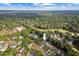 Aerial view of a lovely neighborhood surrounded by lush trees, green golf course and blue sky at 116 Dallavia Ct, Morrisville, NC 27560
