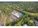 Aerial photograph of community with tennis courts and golf course with tree coverage in the background at 116 Dallavia Ct, Morrisville, NC 27560